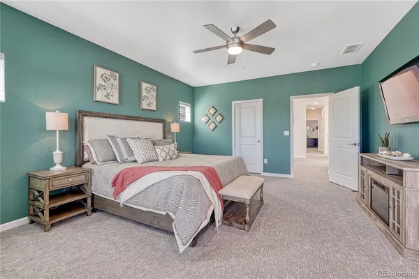 a bedroom with a bed and a chandelier