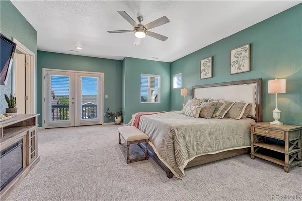 a spacious bedroom with a bed and a large window