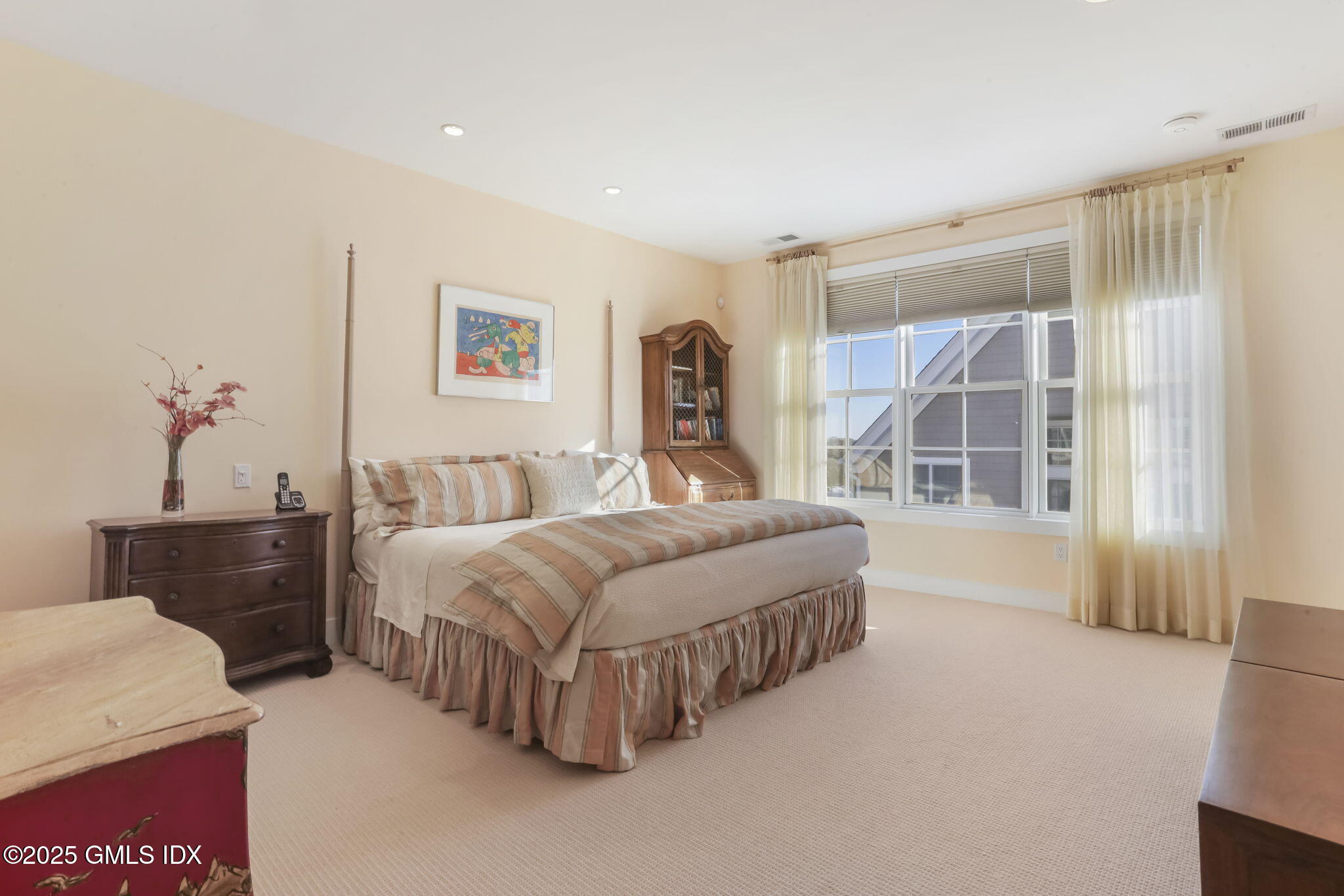 77 Havemeyer Lane, Unit 426 Stamford, CT 06902 - Photo 12 of 23 a spacious bedroom with a bed and a large window