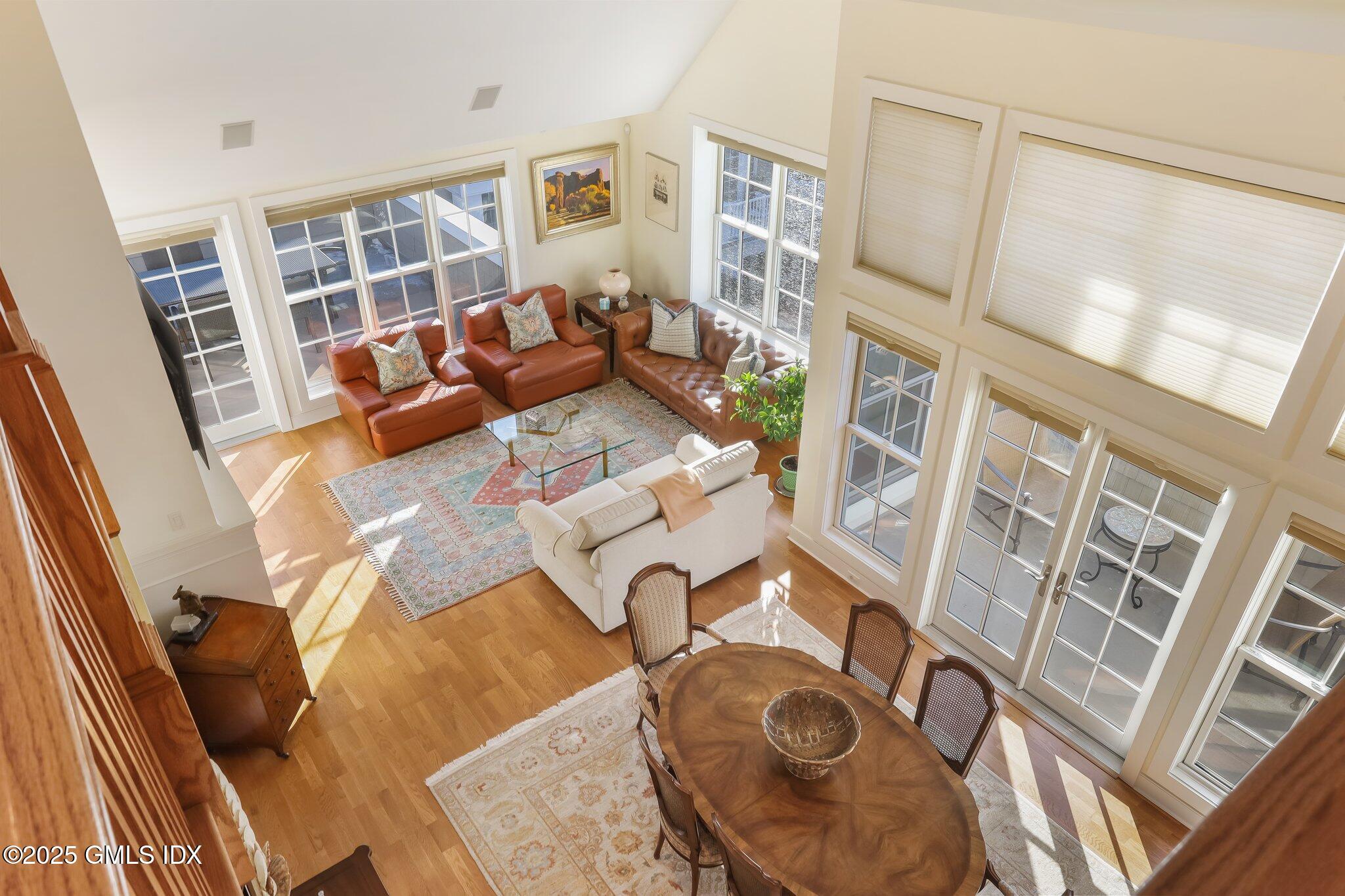77 Havemeyer Lane, Unit 426 Stamford, CT 06902 - Photo 14 of 23 a living room with furniture and a floor to ceiling window