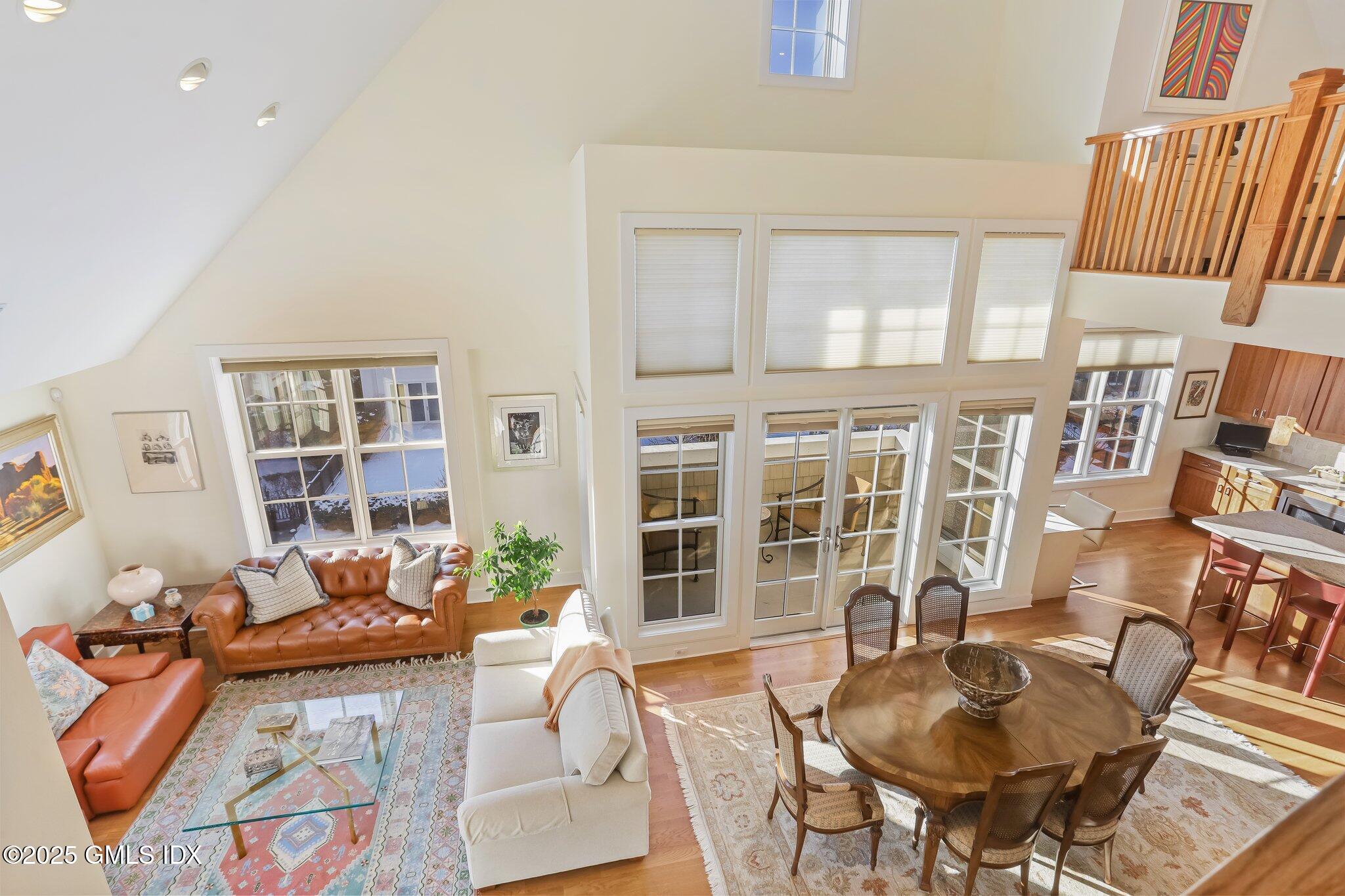 77 Havemeyer Lane, Unit 426 Stamford, CT 06902 - Photo 2 of 23 a living room with furniture and a floor to ceiling window