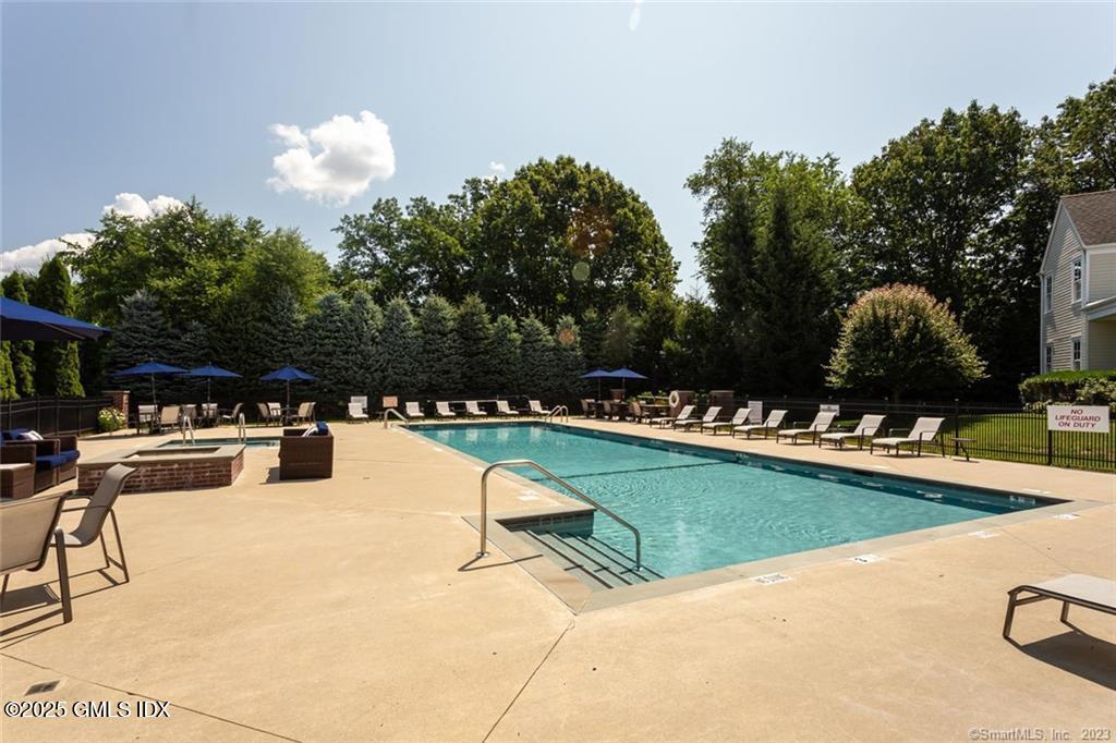 77 Havemeyer Lane, Unit 426 Stamford, CT 06902 - Photo 21 of 23 a view of a swimming pool and lounge chairs