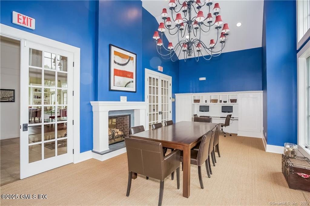 77 Havemeyer Lane, Unit 426 Stamford, CT 06902 - Photo 23 of 23 a dining room with furniture a fireplace and chandelier