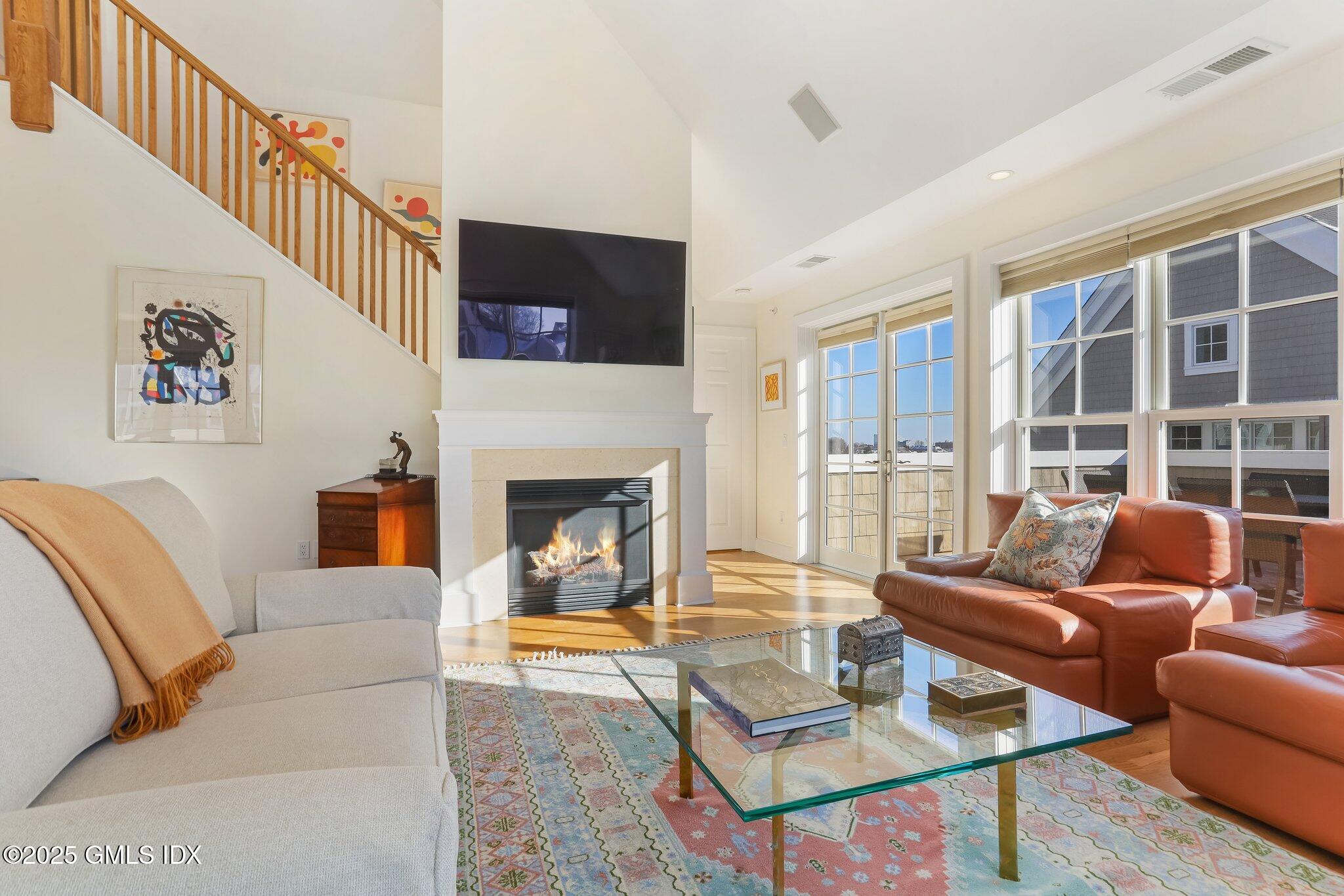 77 Havemeyer Lane, Unit 426 Stamford, CT 06902 - Photo 5 of 23 a living room with furniture fireplace and a flat screen tv