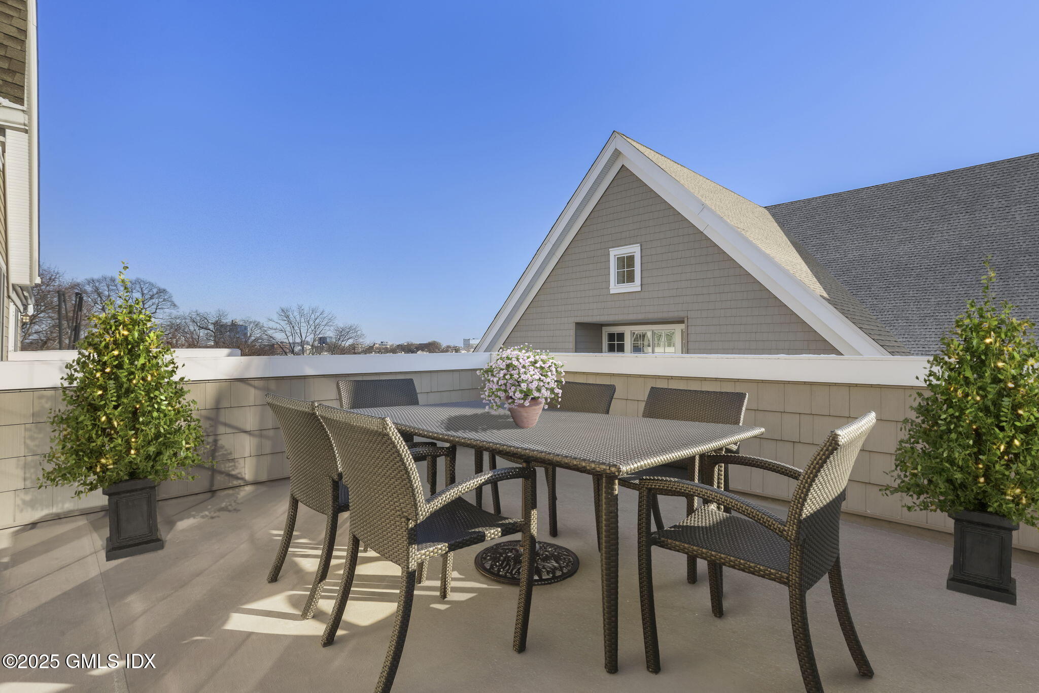 77 Havemeyer Lane, Unit 426 Stamford, CT 06902 - Photo 6 of 23 a roof deck with table and chairs under an umbrella