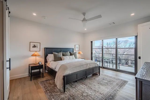 a bedroom with a large bed and a large window