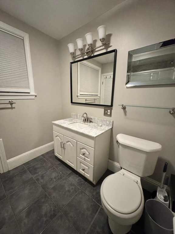 14 East Prospect Street Methuen, MA 01844 - Photo 8 of 9 a bathroom with a toilet sink and mirror