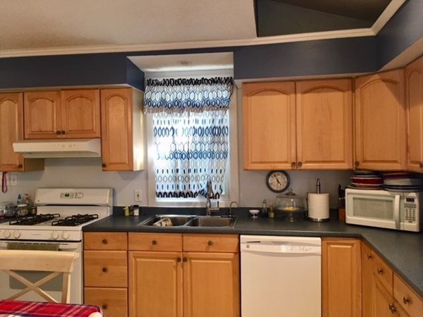 126 Allen Street Springfield, MA 01108 - Photo 4 of 10 a kitchen with stainless steel appliances granite countertop a sink a stove and a microwave