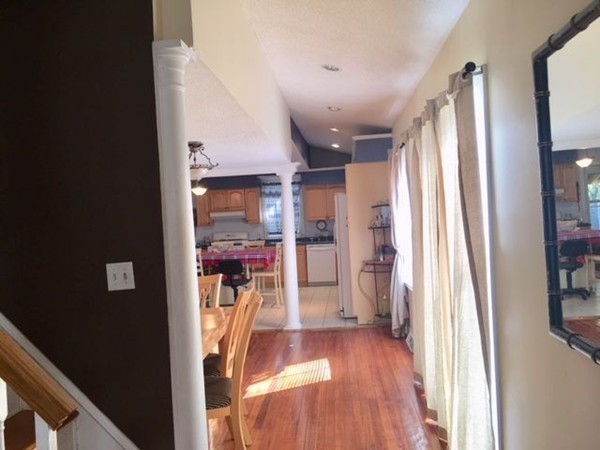 126 Allen Street Springfield, MA 01108 - Photo 5 of 10 a view of a hallway with wooden floor and windows