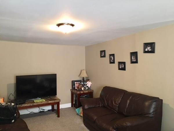 126 Allen Street Springfield, MA 01108 - Photo 7 of 10 a living room with furniture and a flat screen tv