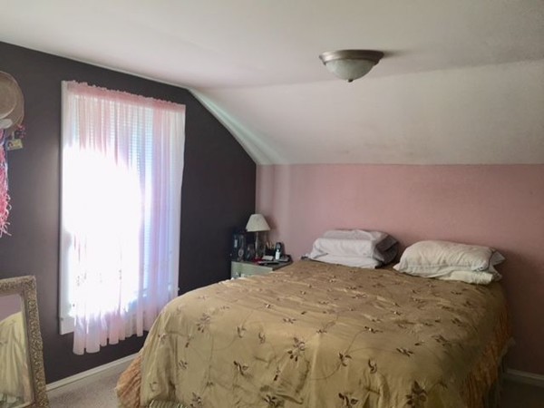 126 Allen Street Springfield, MA 01108 - Photo 8 of 10 a bedroom with a bed and a window