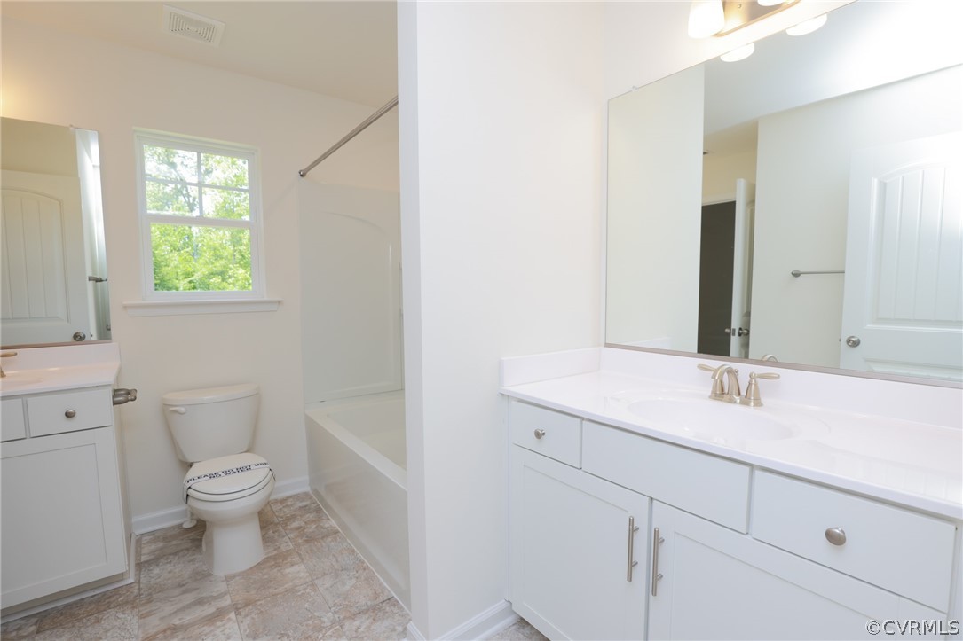 4113 Tosh Lane Chester, VA 23831 - Photo 33 of 47 a bathroom with a sink a toilet and a large mirror