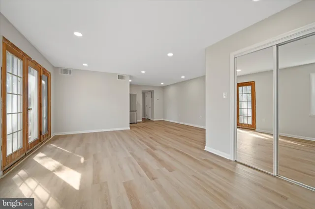 a view of empty room with wooden floor