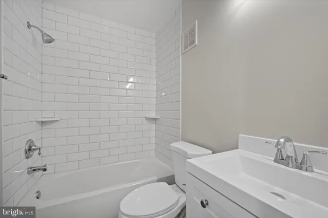 a bathroom with a sink toilet and bathtub