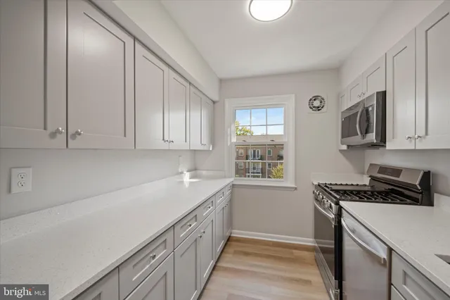 a kitchen that has a sink and a stove