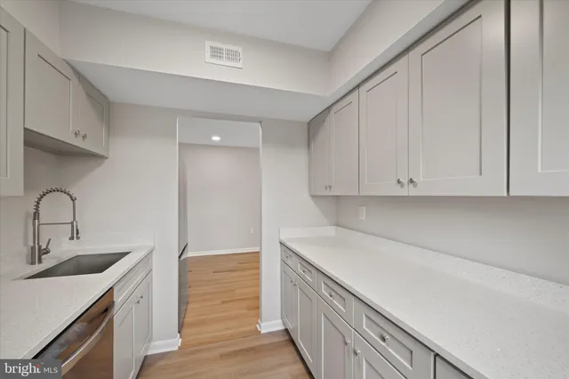 a kitchen with a sink and cabinets