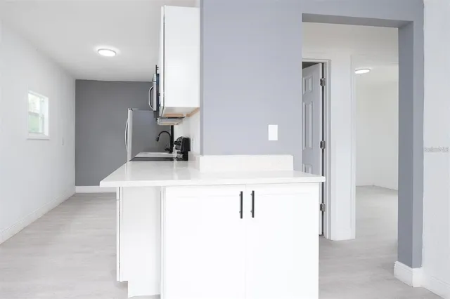 a bathroom with a sink vanity and a mirror