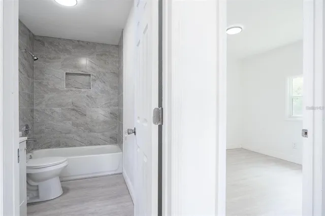 a bathroom with a bathtub and a toilet