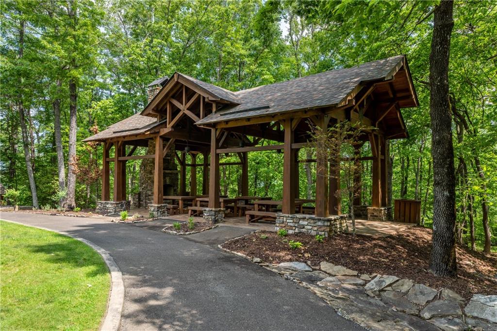 307 Stonehaven Court Jasper, GA 30143 - Photo 12 of 18 a backyard of a house with table and chairs
