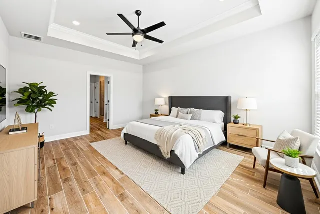 a bedroom with a bed and a potted plant