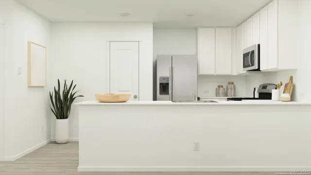 a kitchen with a sink and a refrigerator