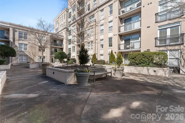a view of a building with garden and sitting area