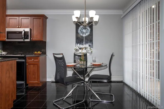 a view of a dining room with furniture and chandelier