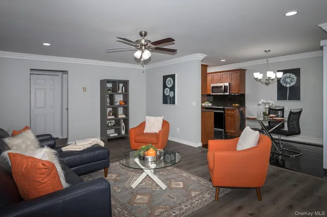 a living room with furniture a ceiling fan and a window