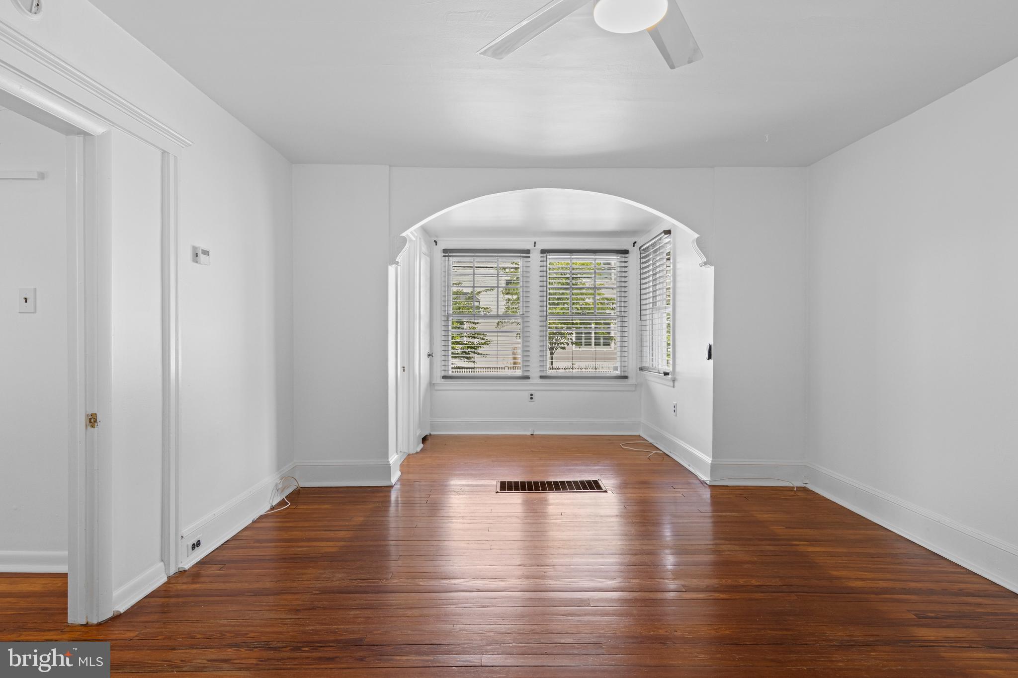 153 Conestoga Road Wayne, PA 19087 - Photo 7 of 13 an empty room with wooden floor and windows