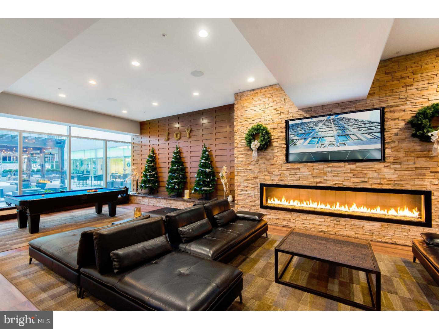 1900-20 Arch Street, Unit 1003 Philadelphia, PA 19103 - Photo 25 of 30 a living room with furniture and a flat screen tv
