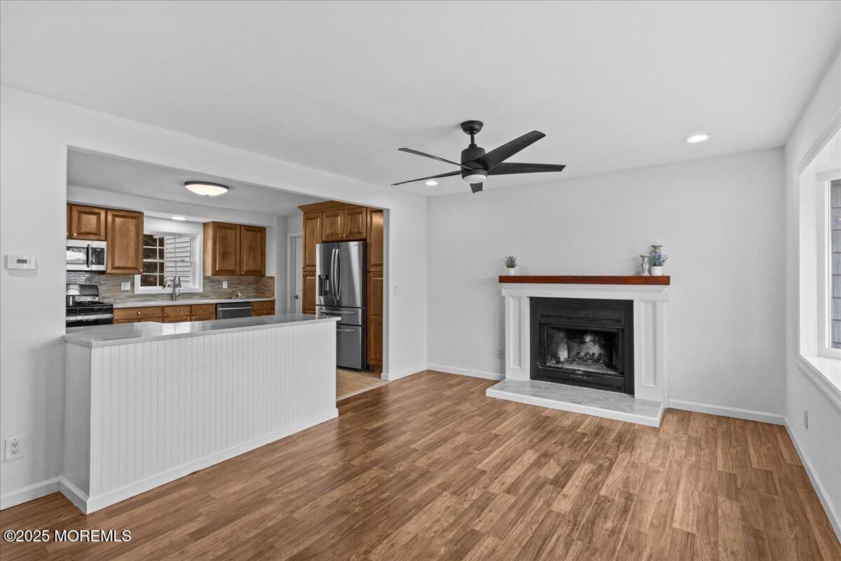 98 Marine Road Waretown, NJ 08758 - Photo 12 of 40 a view of a kitchen and an empty room with wooden floor and a kitchen