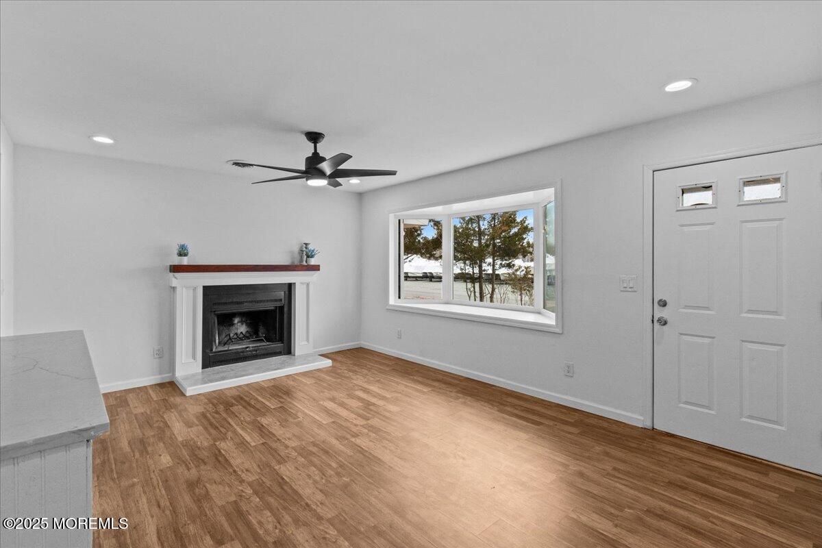 98 Marine Road Waretown, NJ 08758 - Photo 14 of 40 a view of an empty room with a fireplace and a window