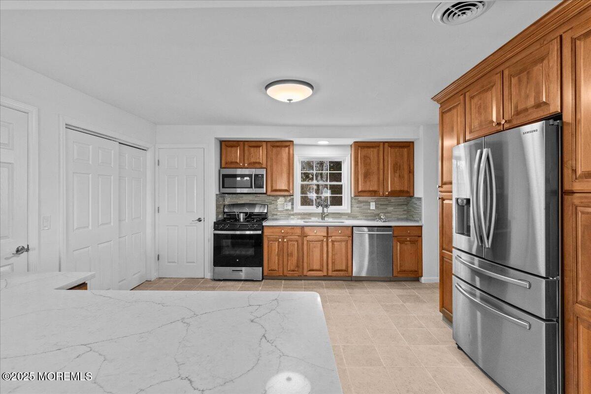 98 Marine Road Waretown, NJ 08758 - Photo 15 of 40 a kitchen with stainless steel appliances a refrigerator and a stove