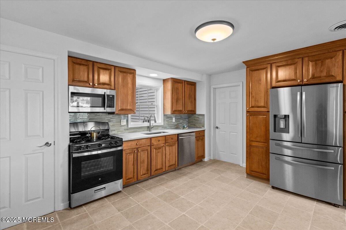 98 Marine Road Waretown, NJ 08758 - Photo 17 of 40 a kitchen with stainless steel appliances granite countertop a refrigerator and a stove top oven