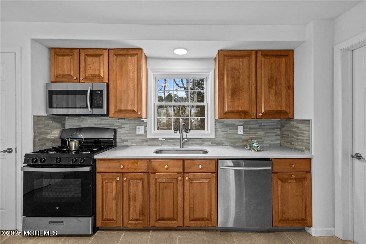98 Marine Road Waretown, NJ 08758 - Photo 18 of 40 a kitchen with stainless steel appliances granite countertop a stove microwave and cabinets