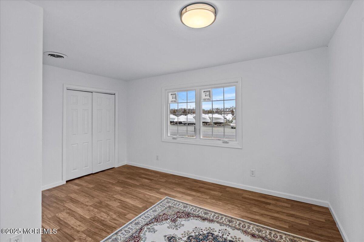 98 Marine Road Waretown, NJ 08758 - Photo 21 of 40 a view of a livingroom with wooden floor and window