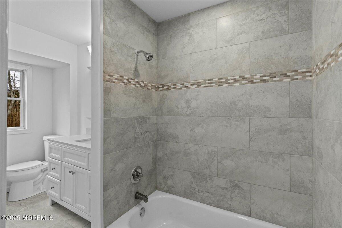 98 Marine Road Waretown, NJ 08758 - Photo 25 of 40 a bathroom with a granite countertop shower a toilet and a sink