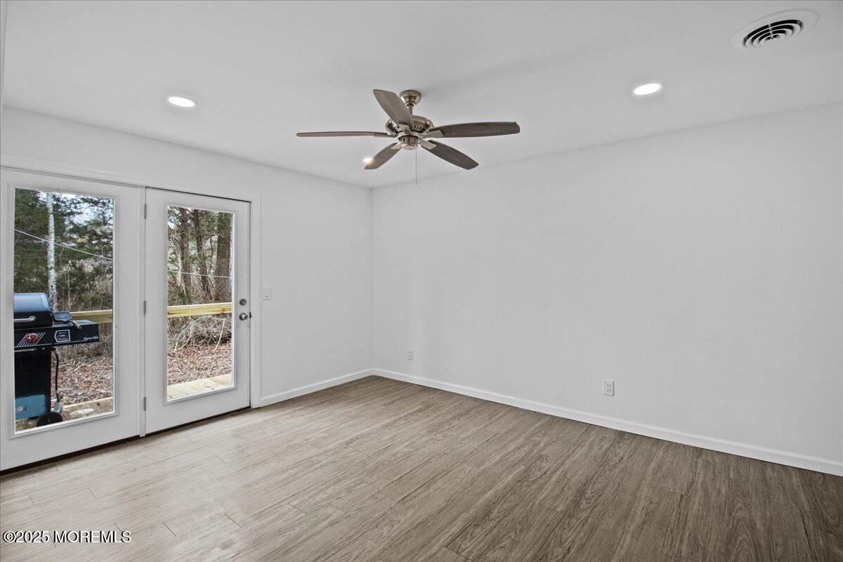 98 Marine Road Waretown, NJ 08758 - Photo 29 of 40 wooden floor in an empty room with a window