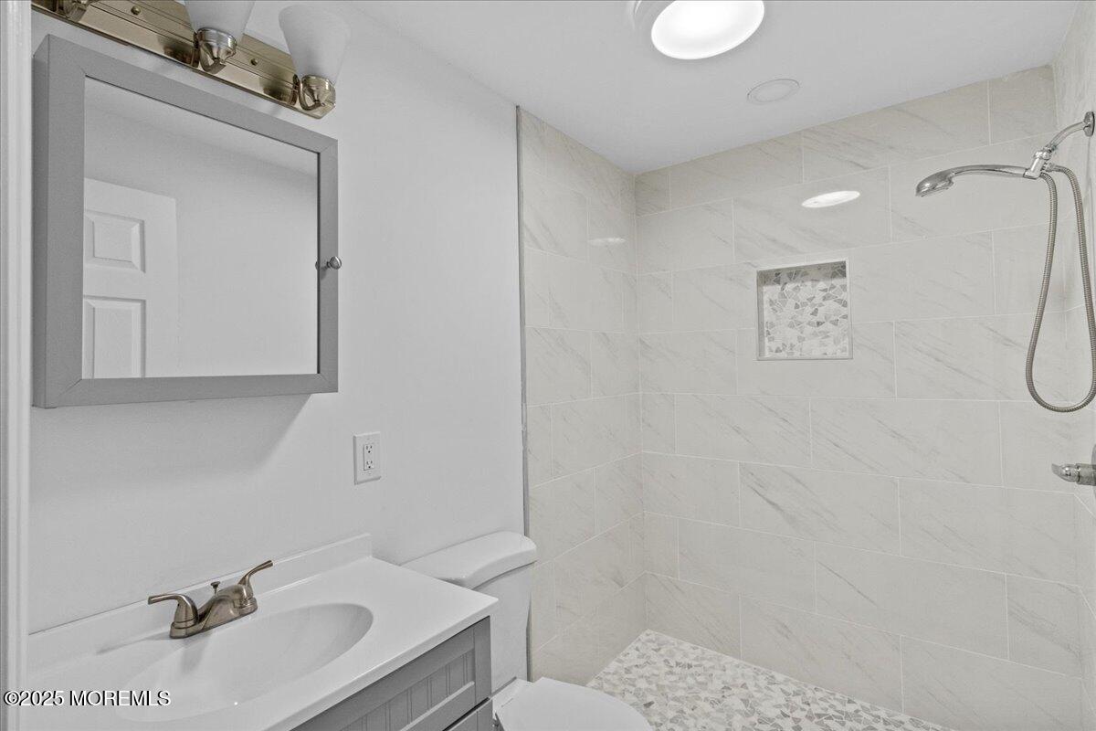98 Marine Road Waretown, NJ 08758 - Photo 32 of 40 a bathroom with a sink toilet and shower