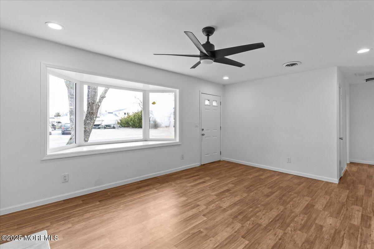98 Marine Road Waretown, NJ 08758 - Photo 9 of 40 a view of a big room with wooden floor closet and windows