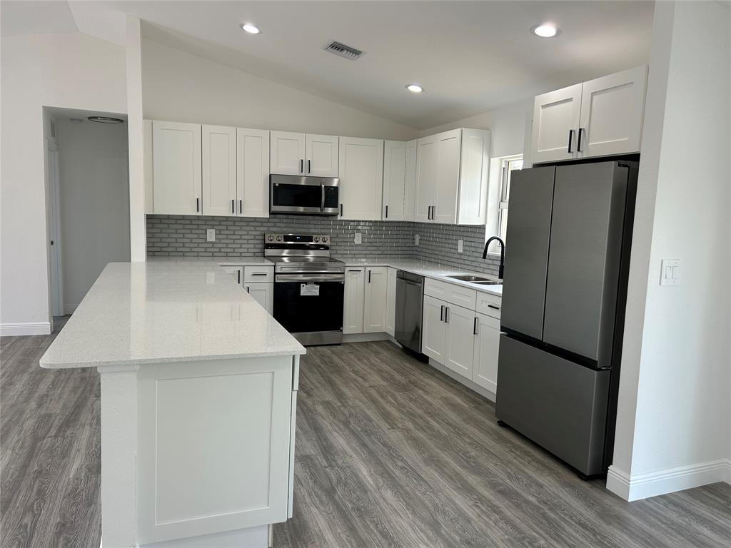 136 Lincoln Road Northwest Lake Placid, FL 33852 - Photo 14 of 31 a kitchen with stainless steel appliances a refrigerator stove microwave and cabinets