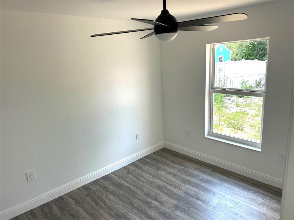 136 Lincoln Road Northwest Lake Placid, FL 33852 - Photo 19 of 31 an empty room with wooden floor fan and windows