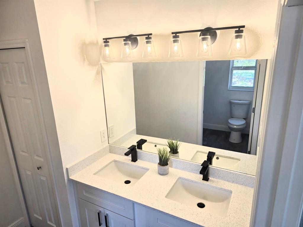 136 Lincoln Road Northwest Lake Placid, FL 33852 - Photo 26 of 31 a bathroom with a sink and a mirror