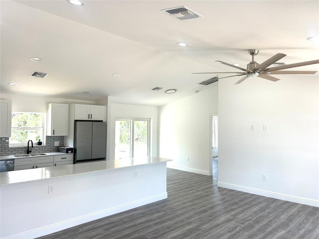 136 Lincoln Road Northwest Lake Placid, FL 33852 - Photo 6 of 31 a view of a kitchen with a refrigerator and a sink