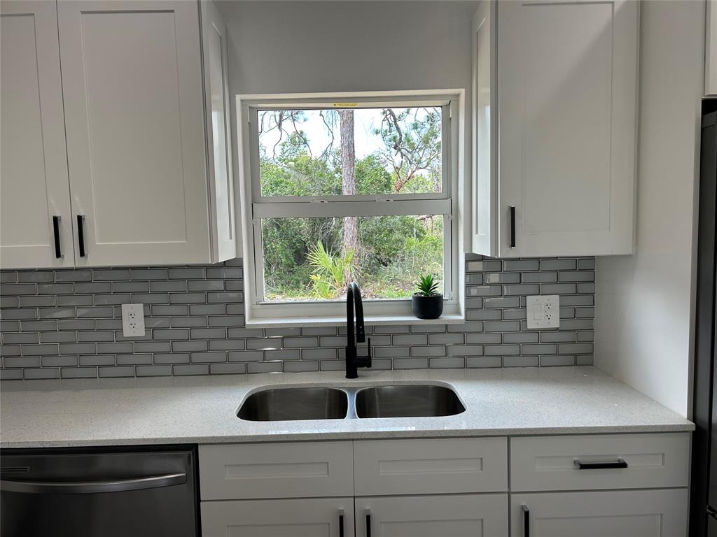 136 Lincoln Road Northwest Lake Placid, FL 33852 - Photo 8 of 31 a kitchen with a sink and a window