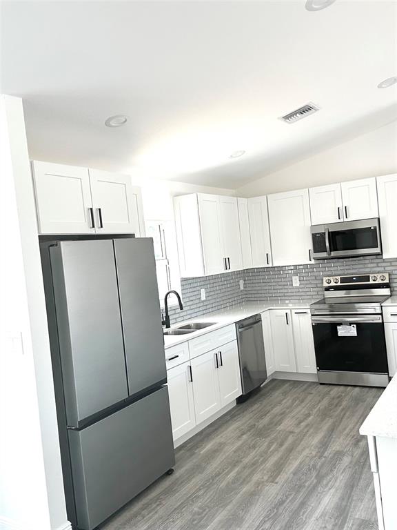 136 Lincoln Road Northwest Lake Placid, FL 33852 - Photo 10 of 31 a kitchen with a white cabinets and white appliances