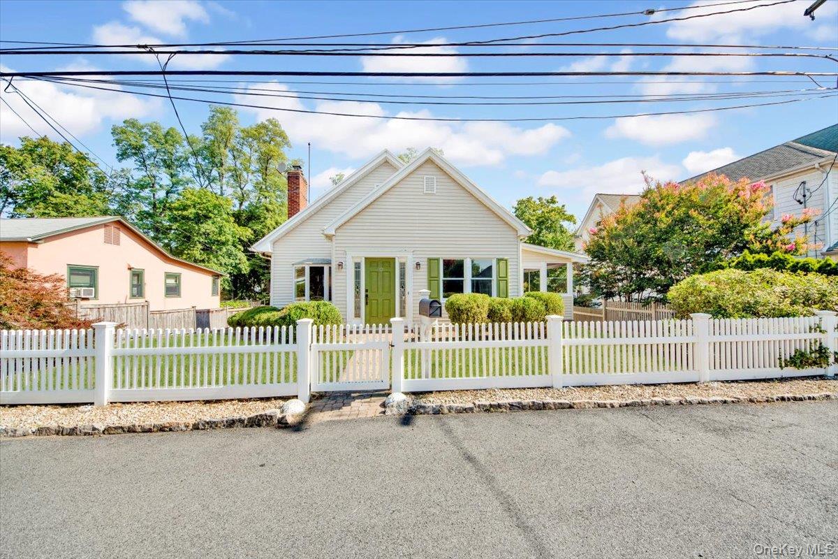 a view of a house with a wooden fence