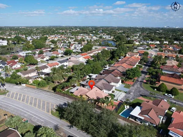 an aerial view of a house with a yard