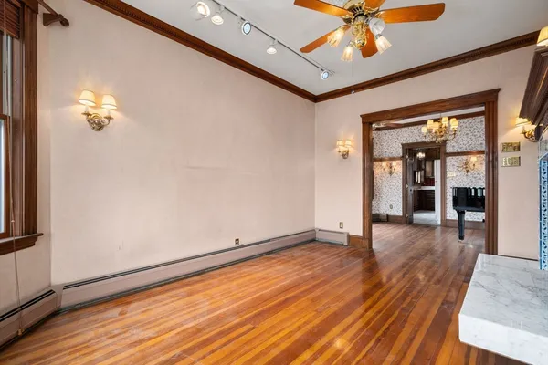 wooden floor in an empty room with a window