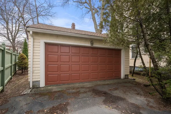 a view of a house with a door and a large tree